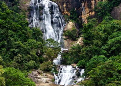 The Beautiful Ravana Falls in Ella cascades over the rocky terrains amidst the verdant surroundings.