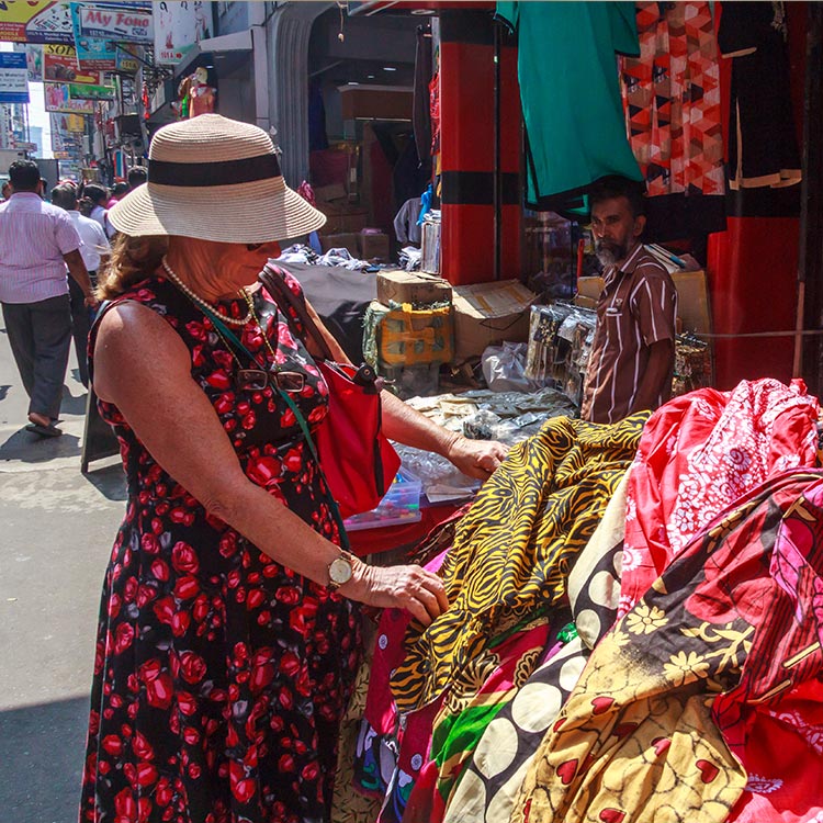 A foreign lady selecting materials at a Shopping stall at a Colombo Street
