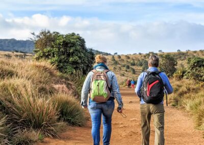 Two foreign boys walking on a dusty path while hiking Horton Plains