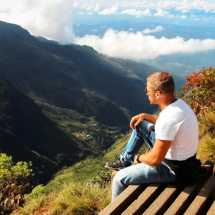 A man sitting on the edge and Enjoying the Surroundings from World's End