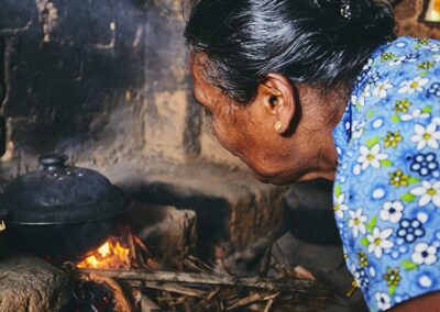 An old lady Cooking a Meal at a Traditional Village House