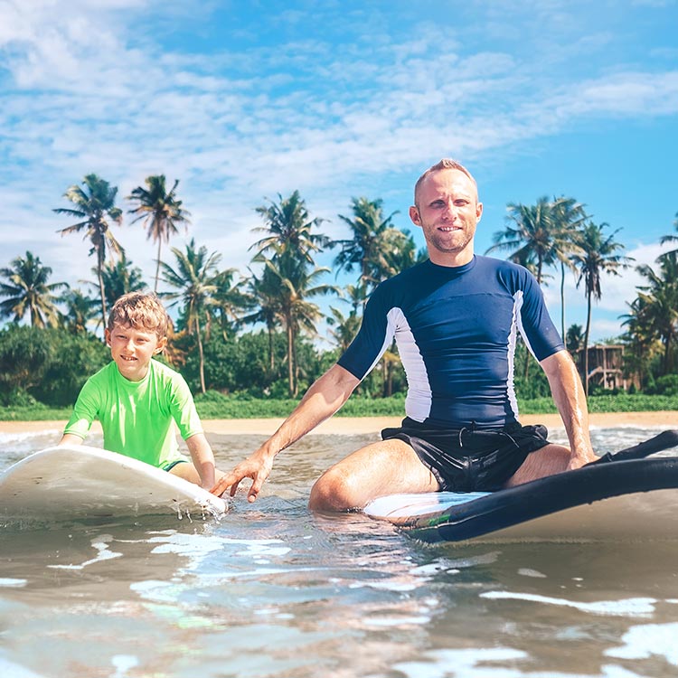 A father and a son trying Water Sports in Sri Lanka