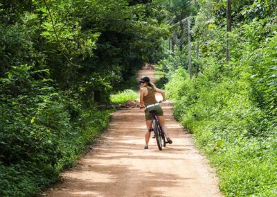 A Girl Wearing Sunglasses Cycling in Polonnaruwa