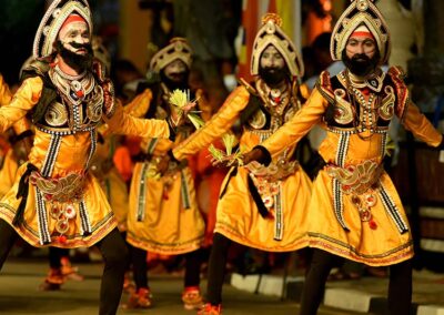 A Group of Traditional Dancers in their orange color dancing costumes