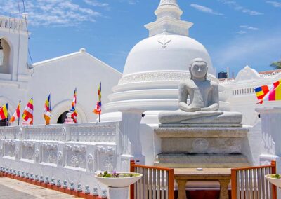 The white stupa, the shrines, and the buddha statue at the City of Galle