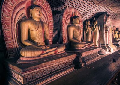 The brownish seated Buddha statues at the Dambulla Cave Temple