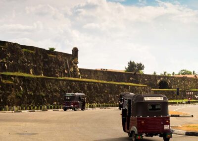 The status in the roundabout, vehicles on the road, and the Galle fort in the Galle City