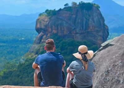 A couple on the top of the Pidurangala rock, looking at the Sigiriya rock fortress