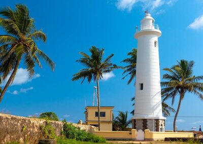 The white lighthouse that stands tall by the stone walls of the Galle Fort