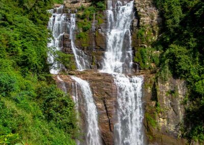 Ramboda Falls flows down over the rocks in the verdant surroundings